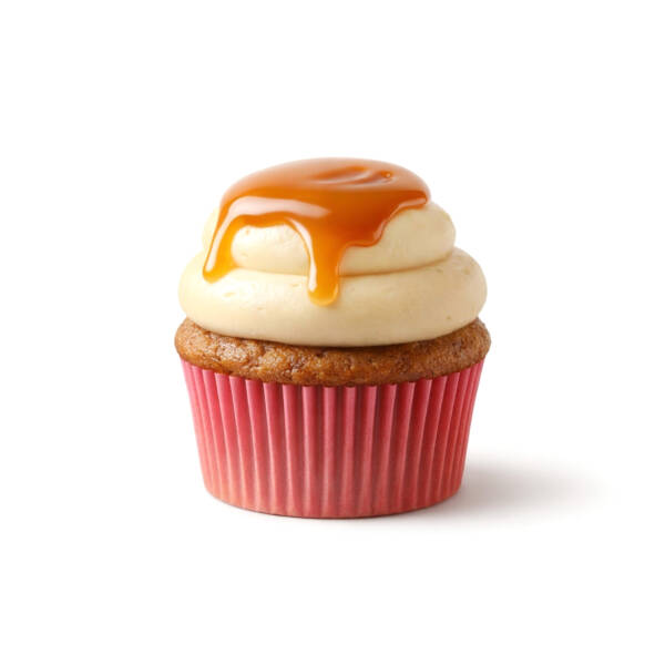 Carrot cake cupcake with caramel buttercream frosting and caramel drizzle on top against a light background